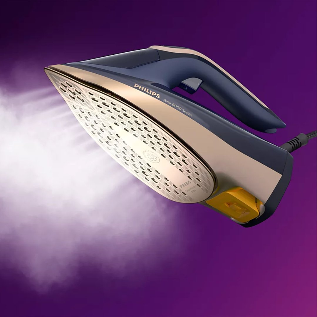 Philips PerfectCare 8000 Series steam iron emitting steam on a purple background