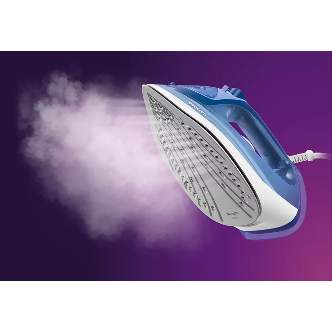 Blue Philips steam iron emitting steam against a purple background