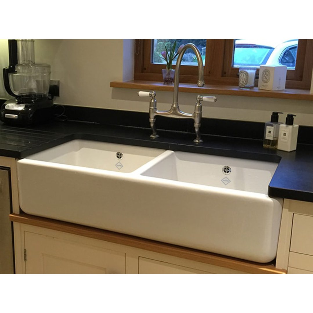 Double bowl 1000 sink in a kitchen with a food processor and window