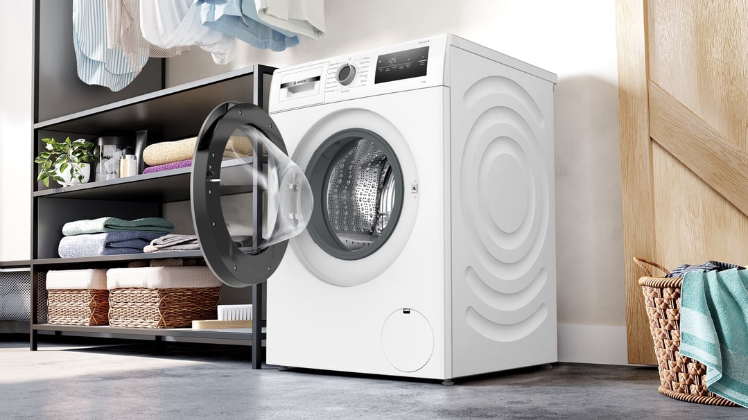 Bosch 8kg front loader washing machine with door open in a laundry room