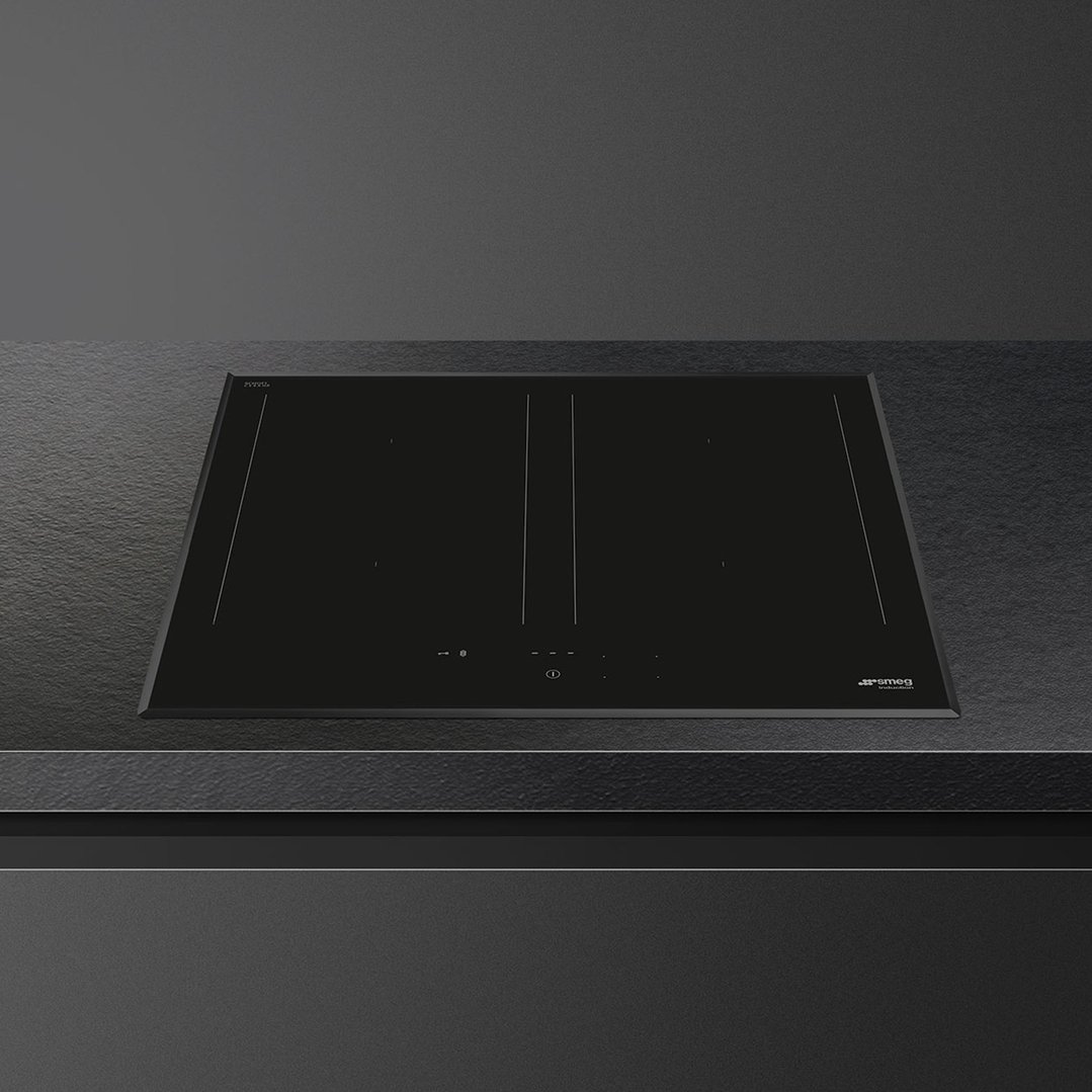 Black induction hob built into a dark grey countertop
