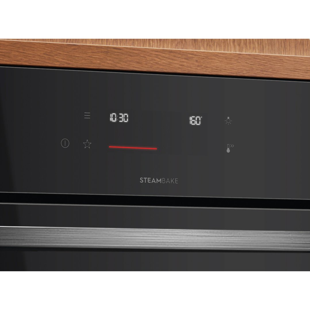 Close up of a black built-in oven control panel with digital display