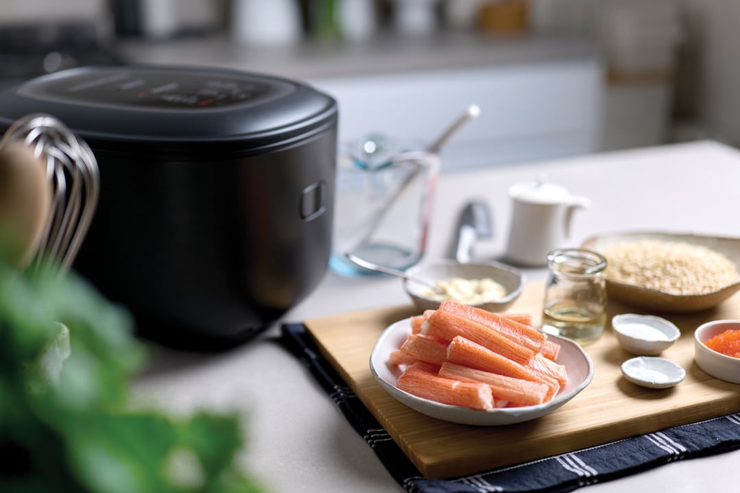 Panasonic Induction Heat Rice Cooker on a kitchen counter with ingredients for cooking
