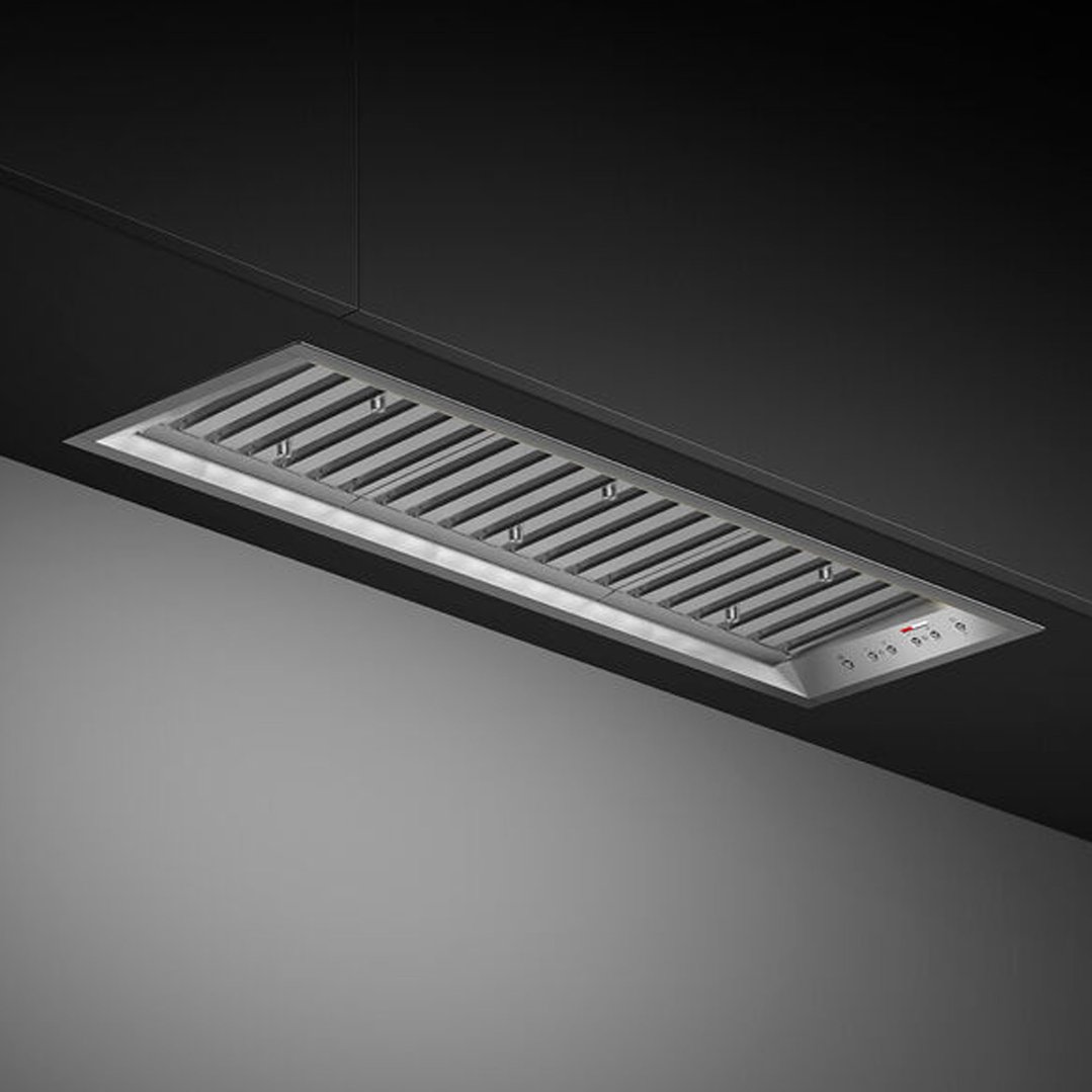 Integrated rangehood with stainless steel grates and controls, installed in a dark ceiling