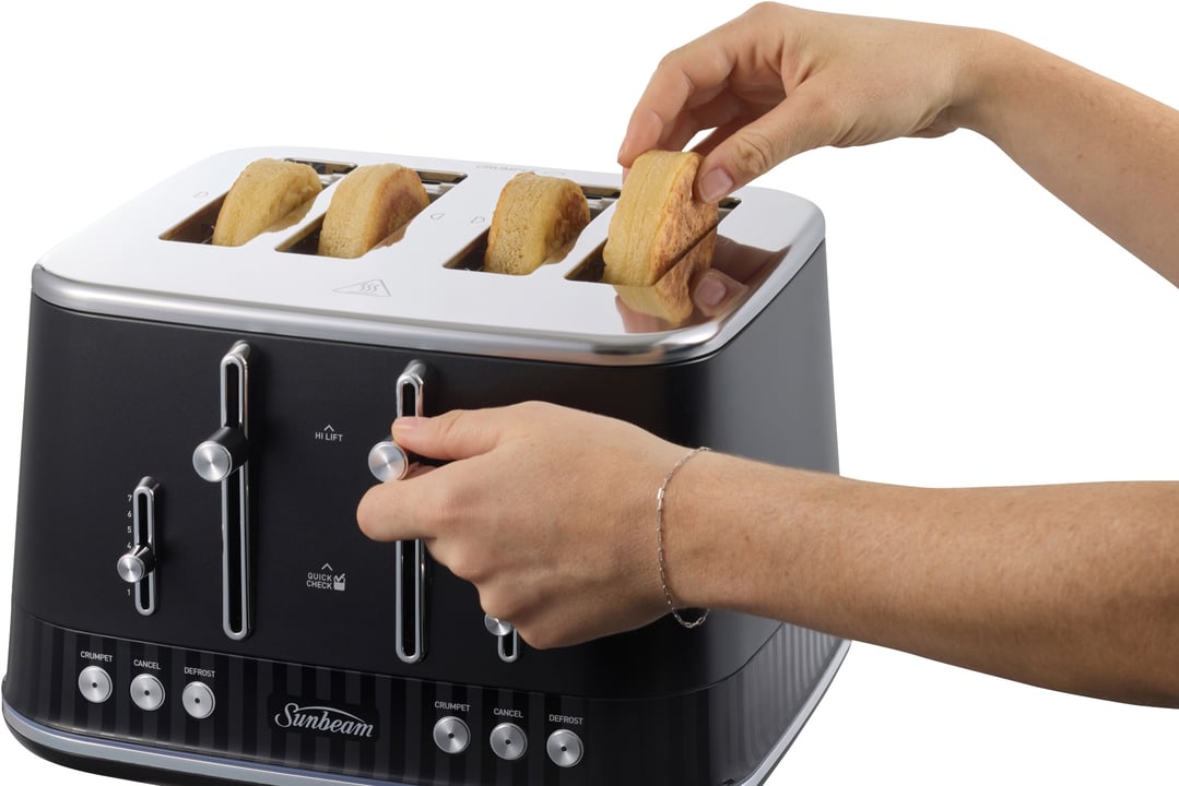 Hands placing toast into a black Sunbeam 4-slice toaster