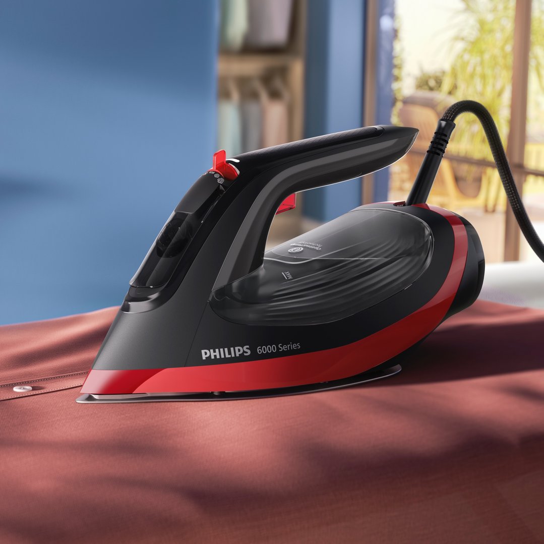 Philips 6000 Series steam iron on a red shirt in a room