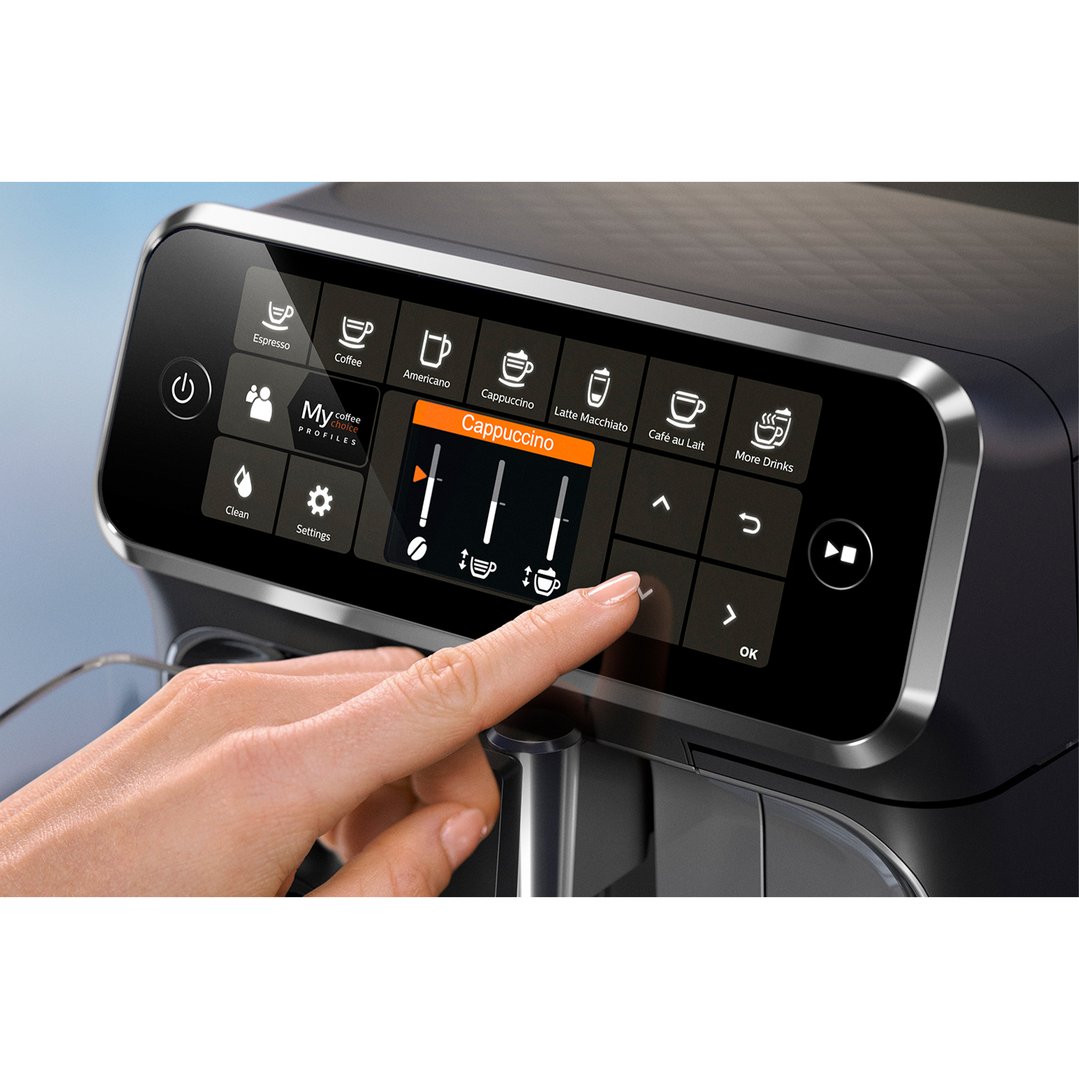 Hand interacting with the touchscreen display of a PHILIPS coffee machine