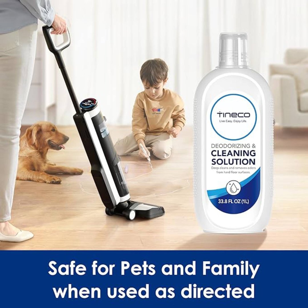 Woman using a Tineco floor cleaner with a child and dog nearby, cleaning solution bottle