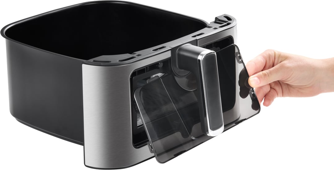 Hand removing the transparent front panel from the air fryer basket