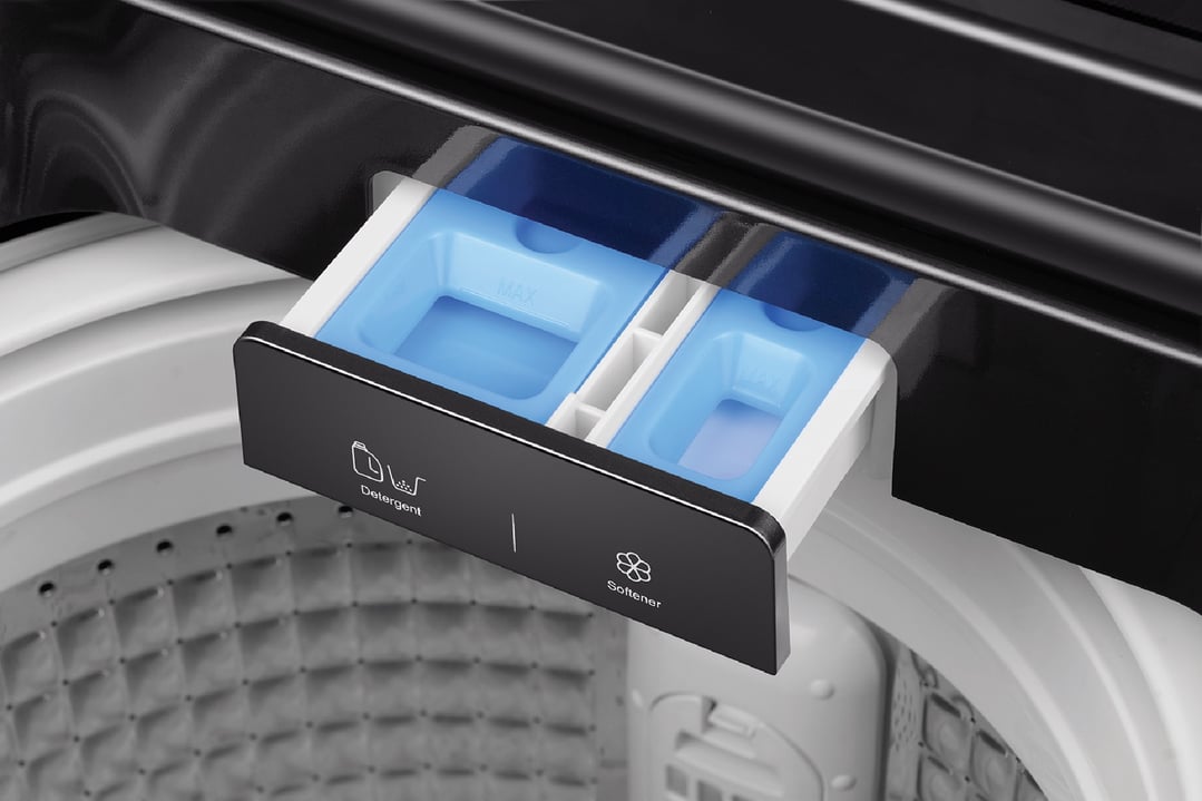 Close up of a washing machine's detergent and softener dispenser
