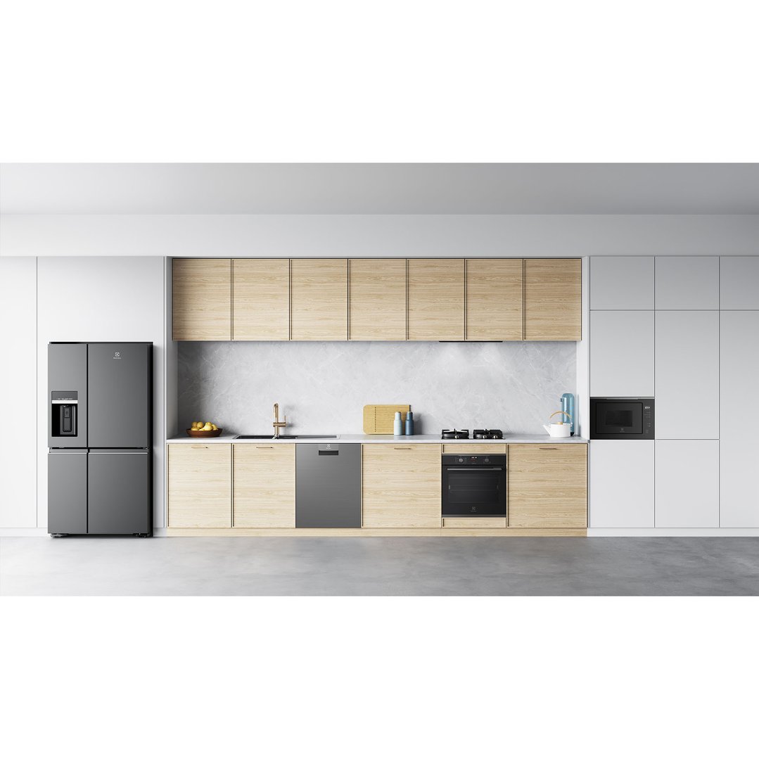 Dark stainless steel oven built into light wood cabinetry in a modern kitchen