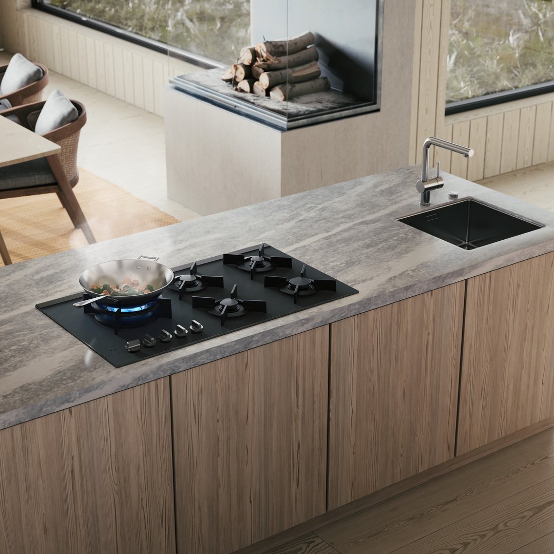 Cooktop with a pan of vegetables cooking on a kitchen island