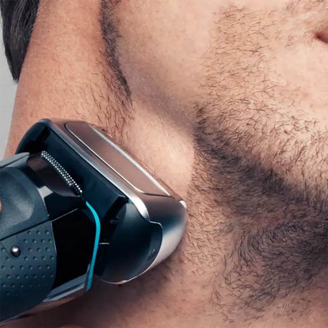 Close up of a man shaving his face with a shaver