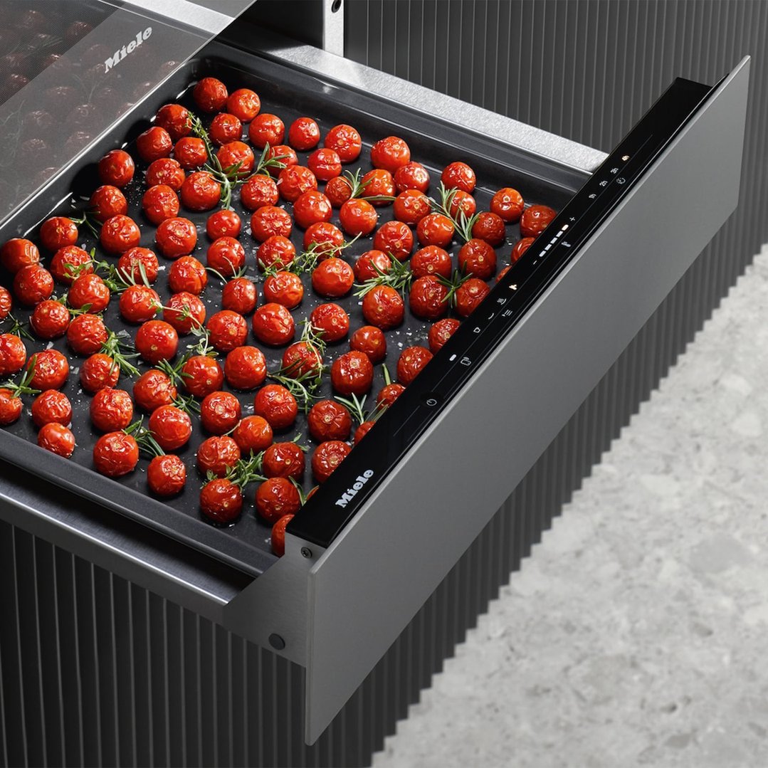 Miele Gourmet Warming Drawer with roasted tomatoes and herbs on a tray