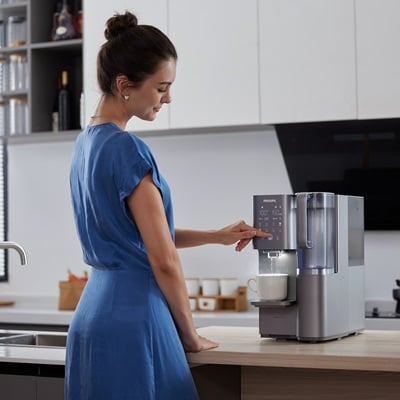 Woman using a water purifier