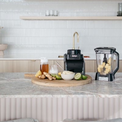 Ninja Blender on a kitchen bench with an assortment of ingredients